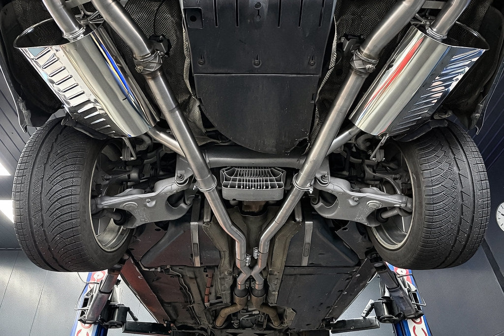 Eisenmann valved stainless steel exhaust installed on BMW E60 M5 highlighting quad tips and performance rear mufflers
